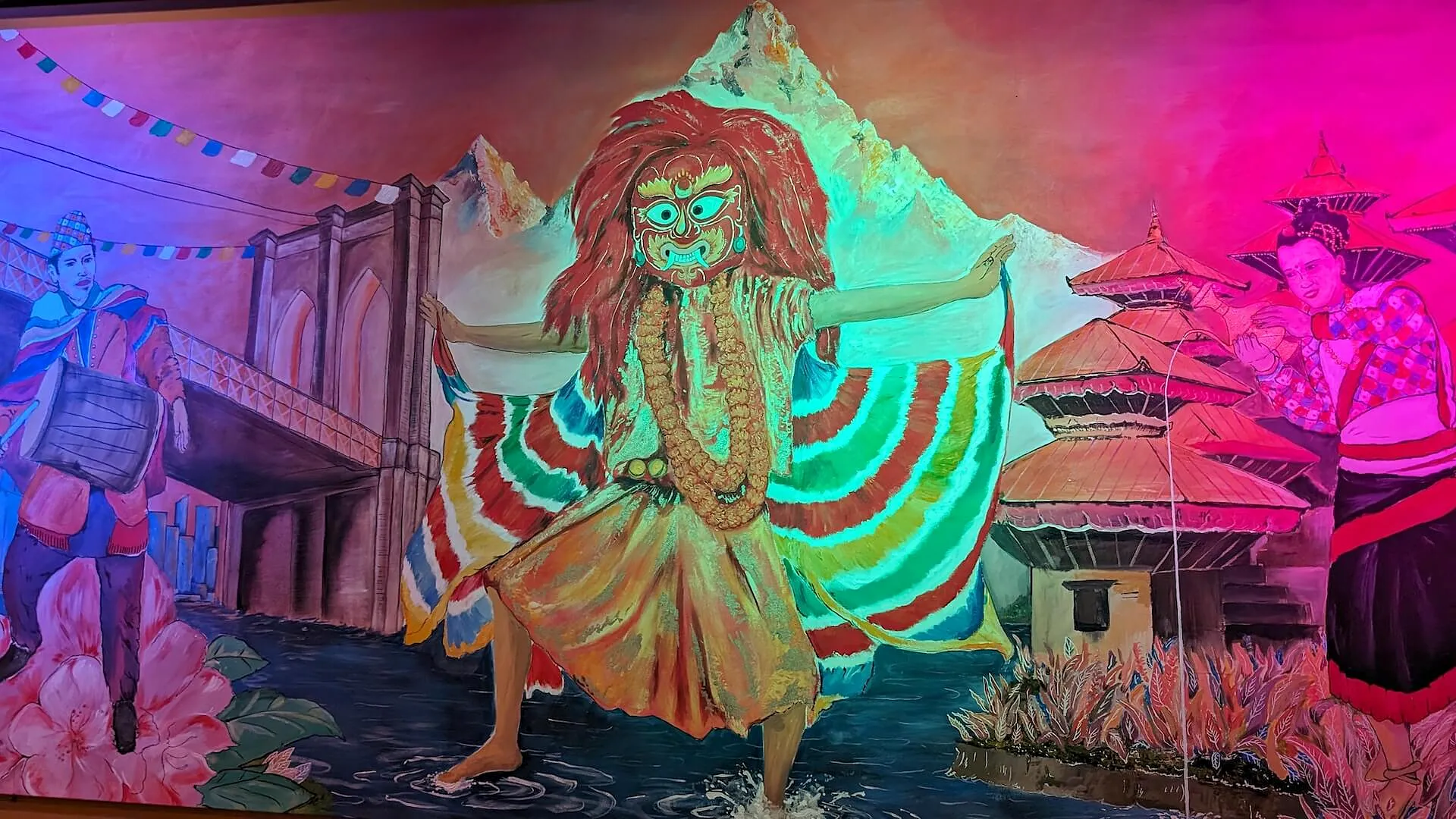 The hand-painted Lakhey dancer across the back wall, against the Himalaya and Newari pagoda houses